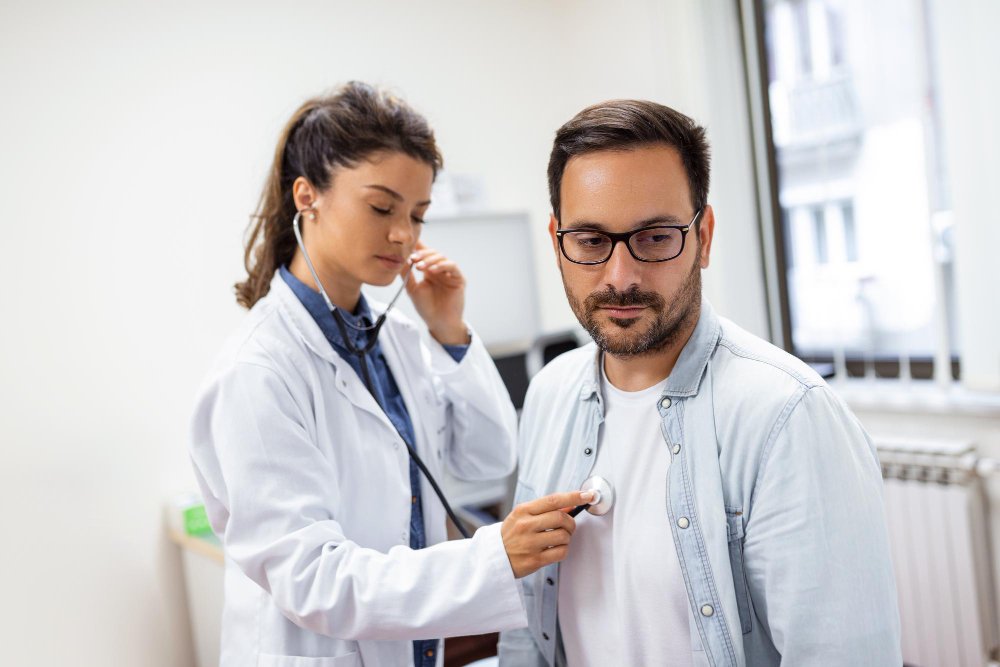 Photo of a healthcare provider performing an asthma check up by listening to a patient’s breathing with a stethoscope. Image used by a medical clinic in San Bernardino to represent asthma care and respiratory health