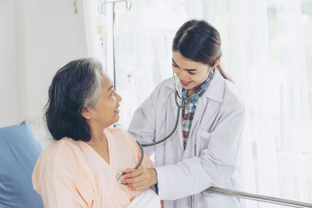 Photo of a healthcare provider performing a heart check up by listening to a patient’s chest with a stethoscope. Image used by a medical clinic in San Bernardino to represent heart health care